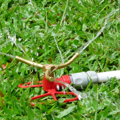 Three-arm brass rotating sprinkler on butterfly base